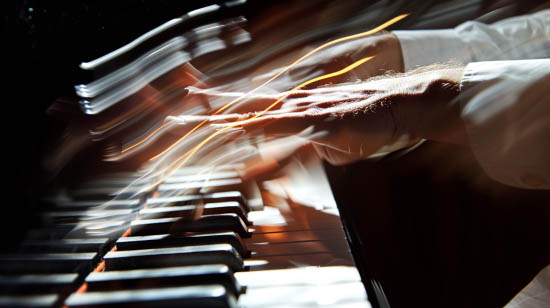 Musician blurred hands at the piano