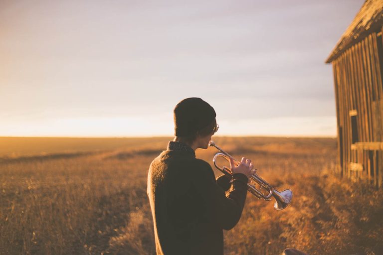 Trumpet player in field
